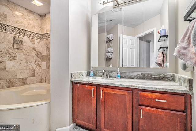 bathroom with tiled shower / bath and vanity