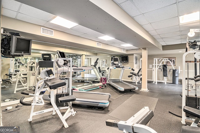 exercise room featuring a paneled ceiling