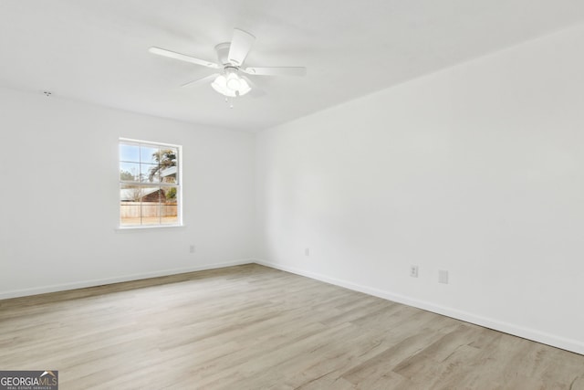 spare room with ceiling fan and light wood-type flooring