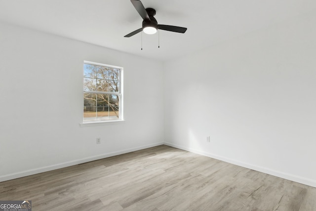 spare room with light hardwood / wood-style flooring and ceiling fan