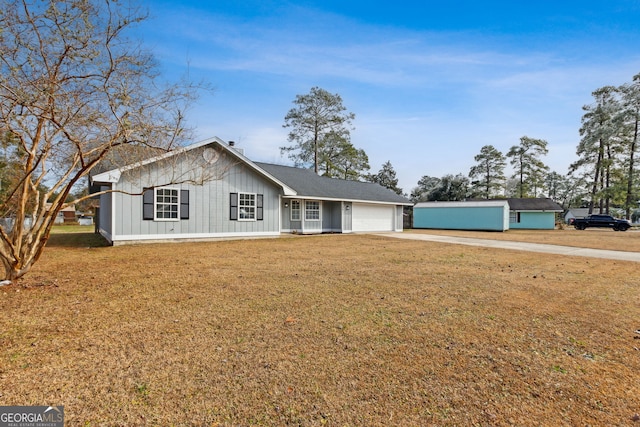 single story home with a garage and a front yard