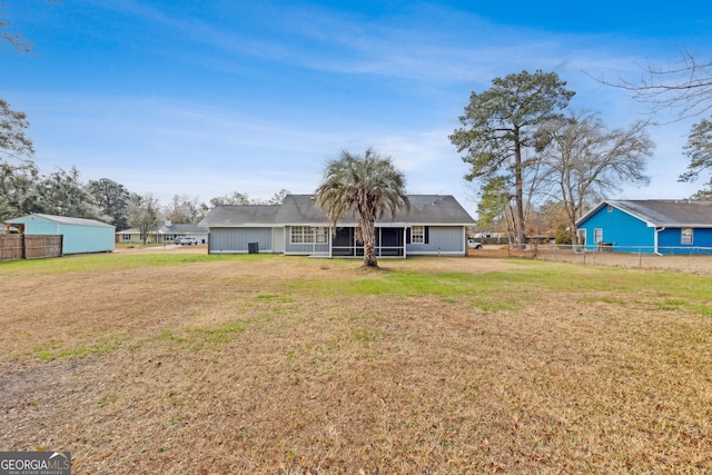 rear view of house with a lawn