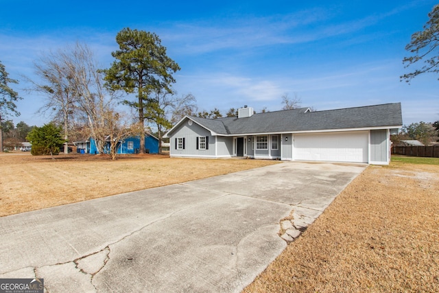 ranch-style house featuring central AC, a garage, and a front lawn