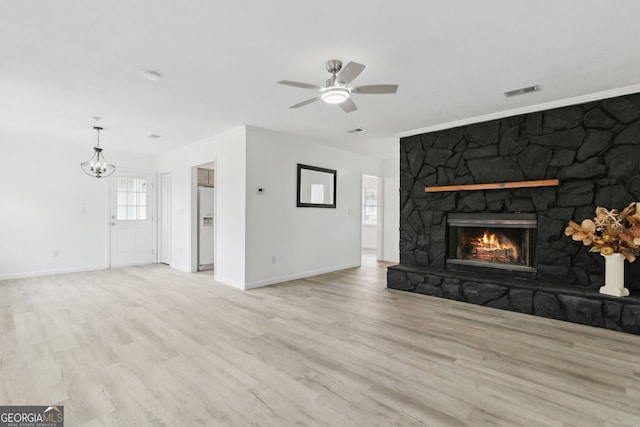 unfurnished living room featuring a fireplace, ceiling fan, and light wood-type flooring