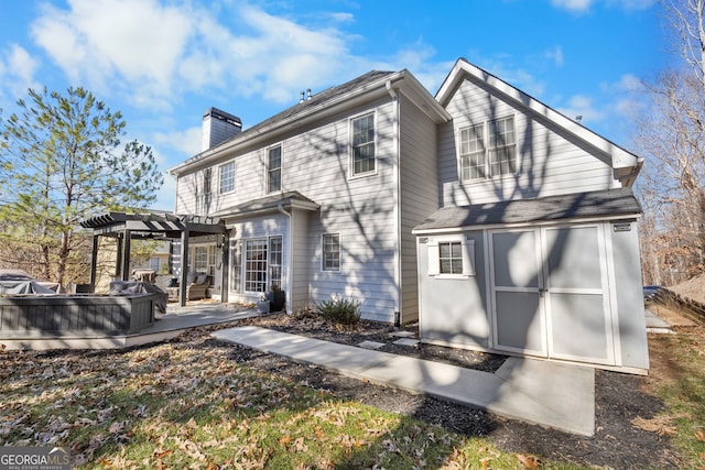 rear view of house with a pergola and a patio