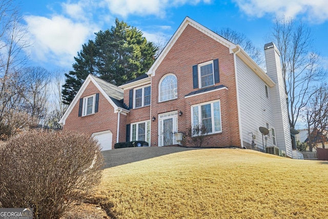 view of front of property with a garage and a front yard