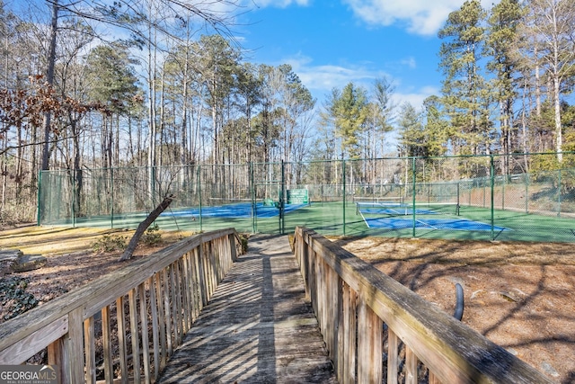 view of home's community with tennis court