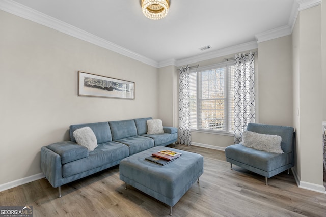 living room with ornamental molding and light hardwood / wood-style floors