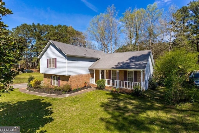 rear view of property with a yard and covered porch