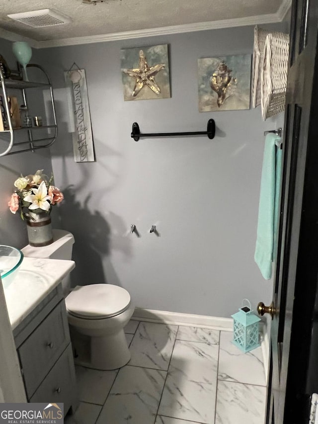 bathroom with vanity, crown molding, toilet, and a textured ceiling