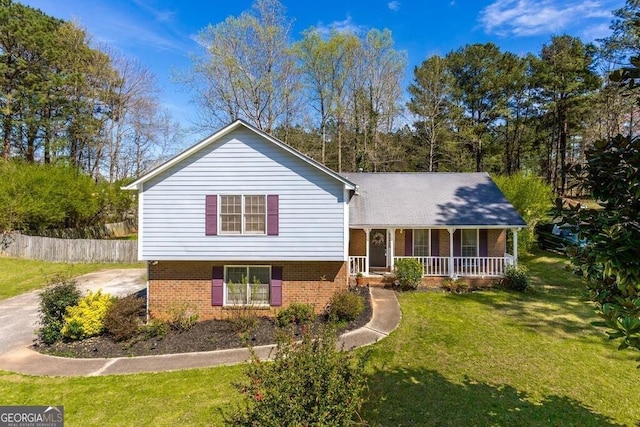 split level home featuring covered porch and a front yard