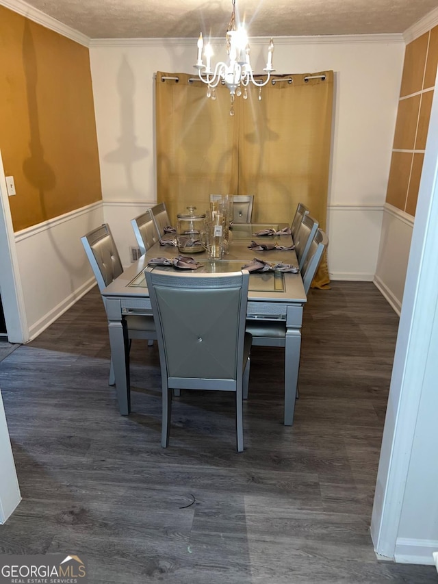 unfurnished dining area featuring an inviting chandelier, dark hardwood / wood-style flooring, ornamental molding, and a textured ceiling