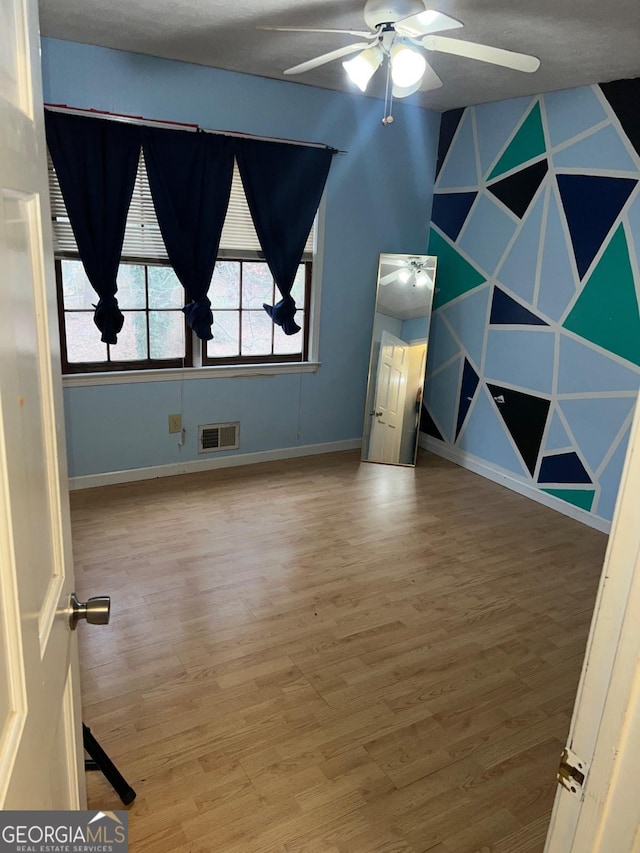 spare room featuring ceiling fan and wood-type flooring