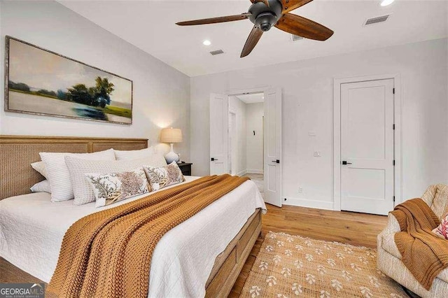 bedroom with ceiling fan and light wood-type flooring