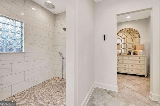 bathroom with vanity and a tile shower