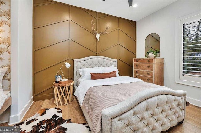 bedroom with ceiling fan and hardwood / wood-style floors