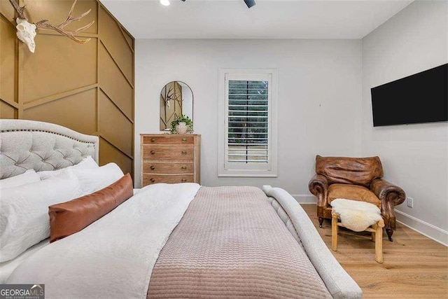 bedroom with ceiling fan and hardwood / wood-style floors