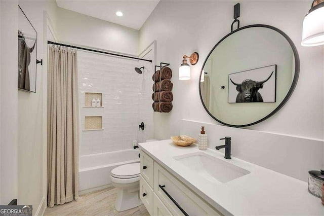 full bathroom with vanity, shower / tub combo with curtain, and toilet