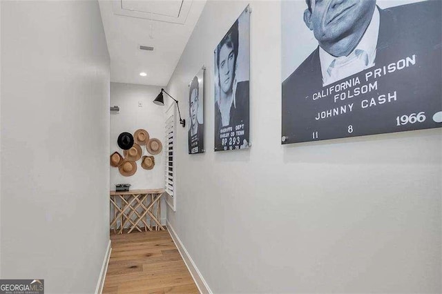 corridor with hardwood / wood-style floors