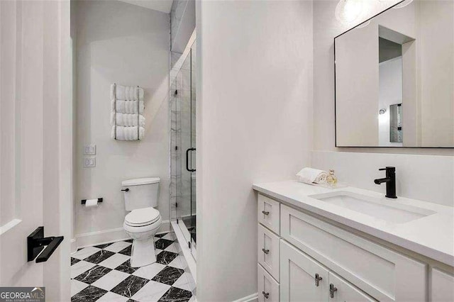 bathroom with vanity, toilet, and an enclosed shower