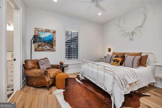 bedroom with hardwood / wood-style flooring and ceiling fan