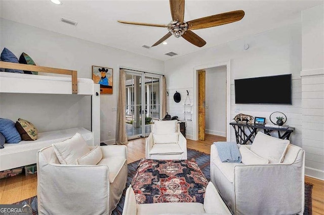 bedroom with light hardwood / wood-style flooring, access to outside, french doors, and ceiling fan