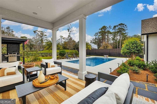 view of pool with a patio, an outdoor hangout area, and grilling area