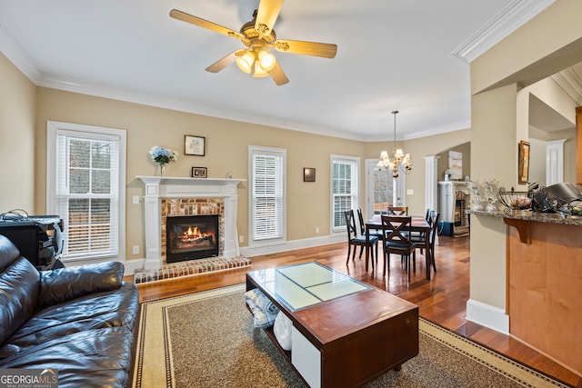 living room with dark hardwood / wood-style floors, a wealth of natural light, and a fireplace