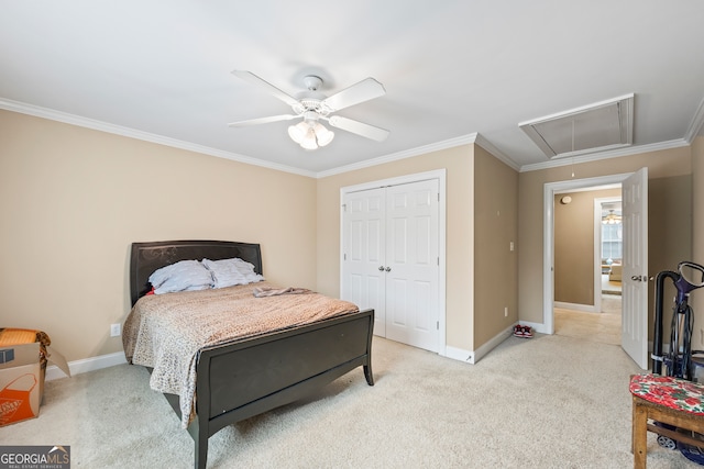 carpeted bedroom with ceiling fan, ornamental molding, and a closet