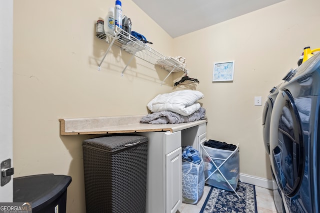 laundry room featuring washer and dryer and light tile patterned floors