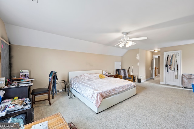 bedroom with ceiling fan, vaulted ceiling, and carpet