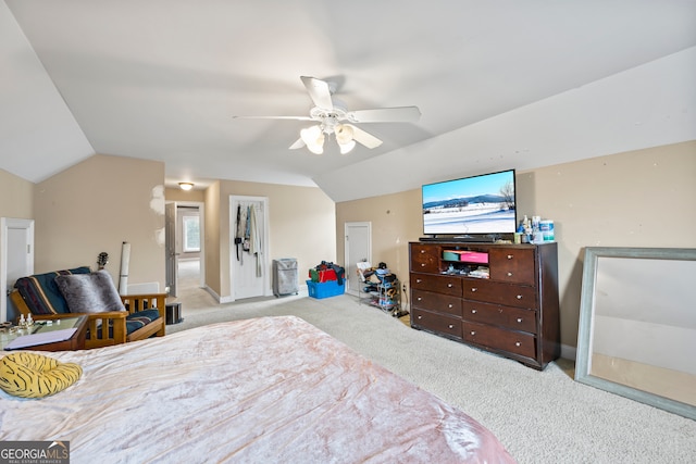 bedroom with vaulted ceiling, light colored carpet, and ceiling fan