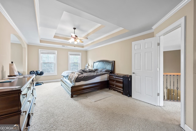 carpeted bedroom featuring a raised ceiling, crown molding, and ceiling fan