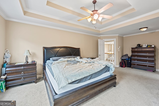 bedroom featuring ornamental molding, a raised ceiling, ceiling fan, and carpet