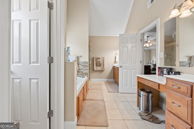 bathroom featuring tile patterned flooring, vanity, ceiling fan, and a tub to relax in