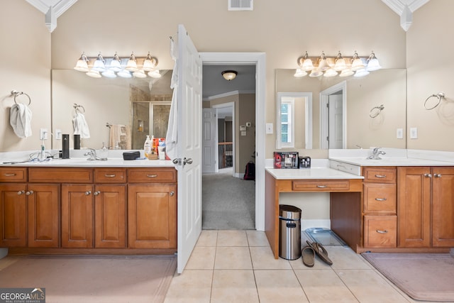 bathroom featuring tile patterned flooring, vanity, crown molding, and a shower with door