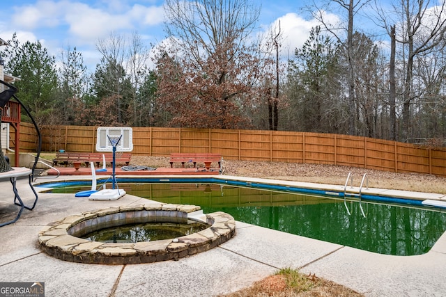 view of pool with an in ground hot tub