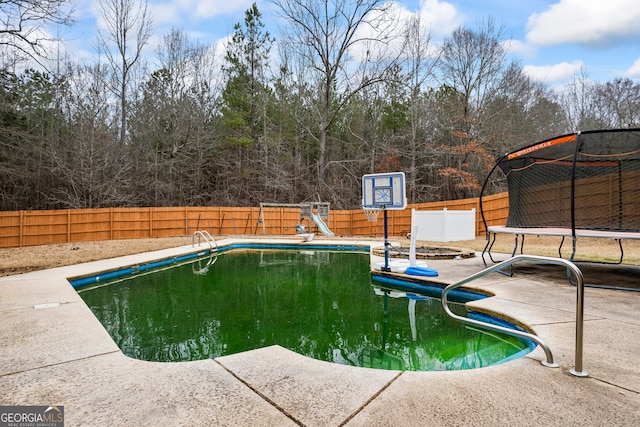 view of pool with a playground and a trampoline