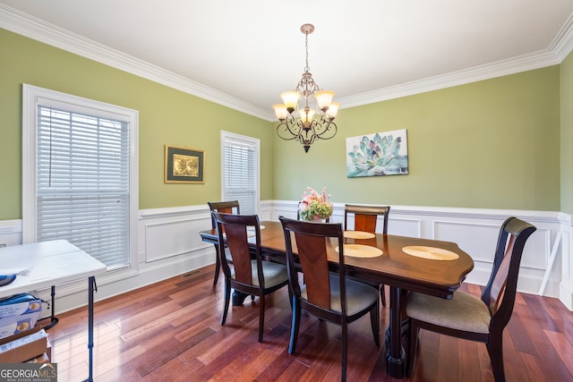 dining room with a notable chandelier, wood-type flooring, and ornamental molding