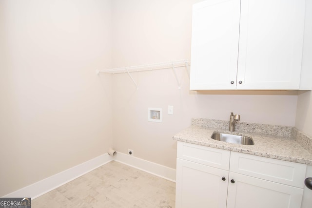 clothes washing area with washer hookup, sink, cabinets, and hookup for an electric dryer