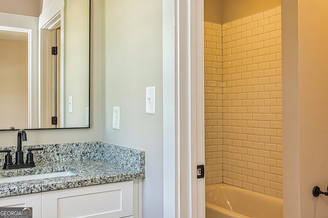 bathroom featuring vanity and a washtub