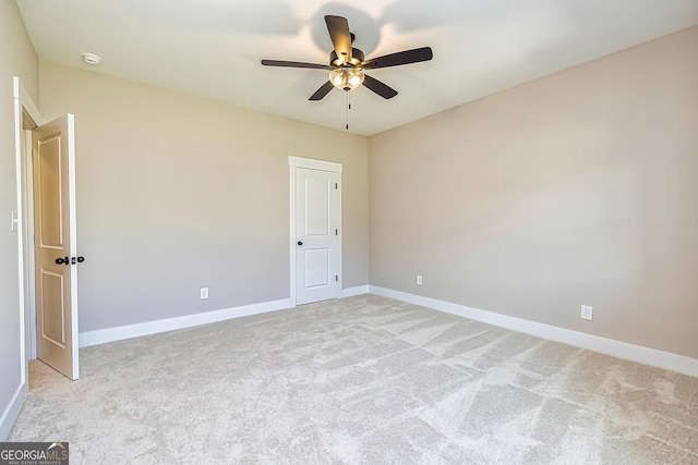 spare room with light carpet and ceiling fan