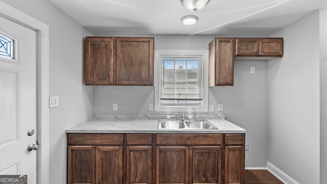 kitchen with sink, hardwood / wood-style floors, and dark brown cabinetry