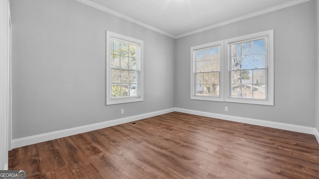 unfurnished room featuring wood-type flooring and ornamental molding