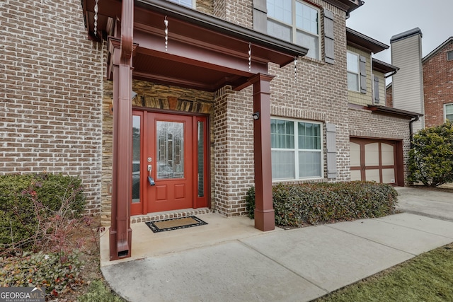 view of exterior entry with a garage