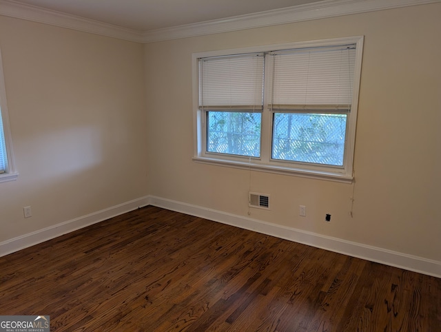 unfurnished room featuring baseboards, dark wood-style flooring, and crown molding
