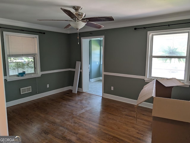 spare room featuring ceiling fan, wood finished floors, crown molding, and baseboards