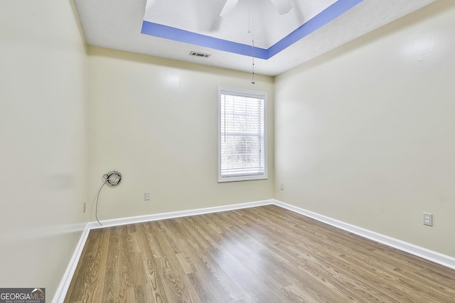 unfurnished room with ceiling fan and light wood-type flooring