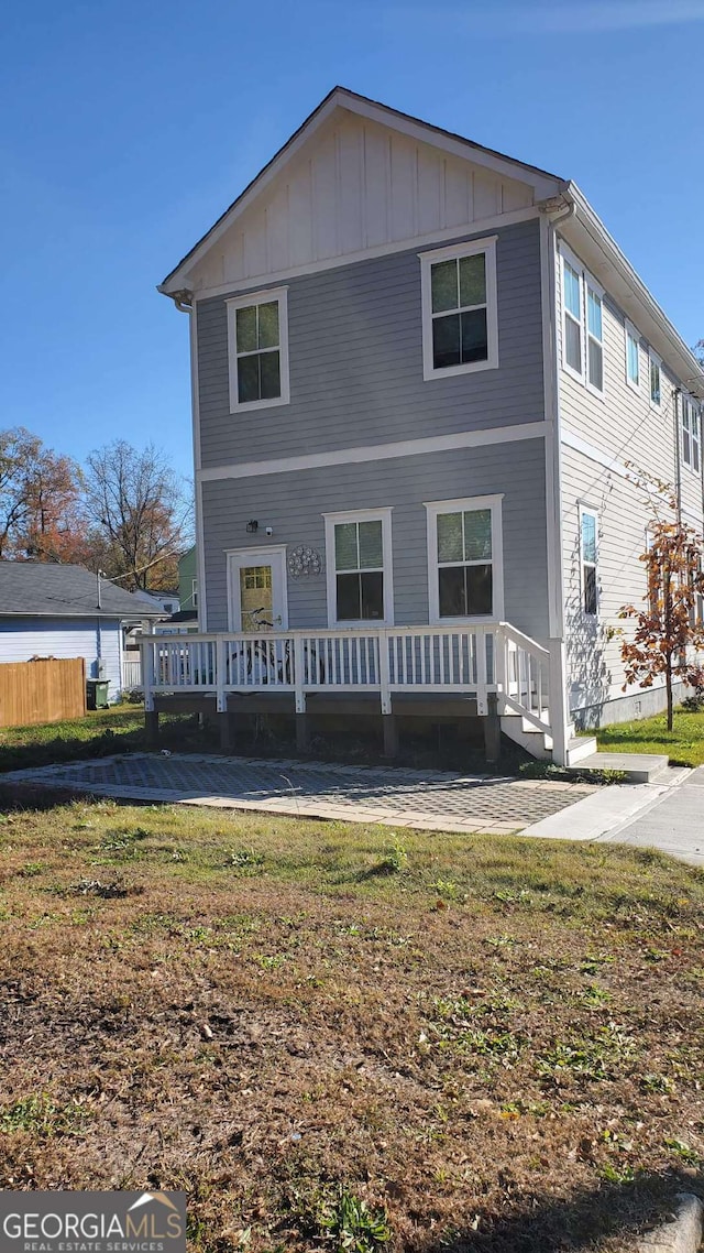 back of house with a lawn