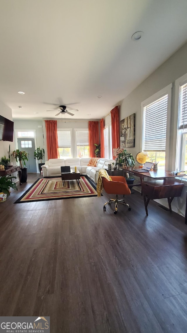 living room featuring wood-type flooring and ceiling fan